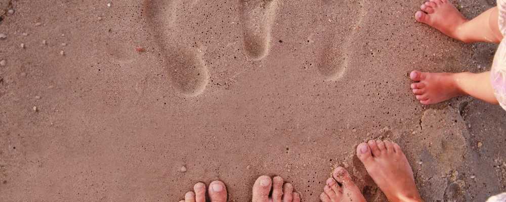 Footprints in the sand on a Greek beach
