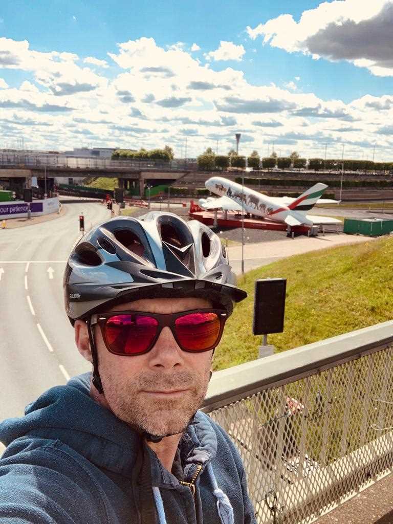 Chris cycling past Heathrow airport