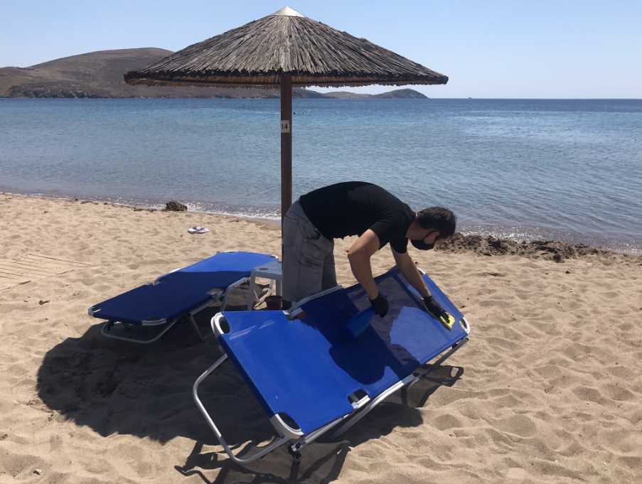 Disinfecting the sun loungers on Platy beach, Lemnos