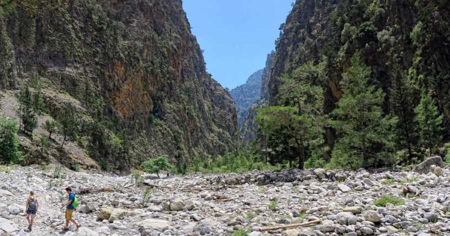 People hiking on trail through Samaria gorge. (Crete, Greece)