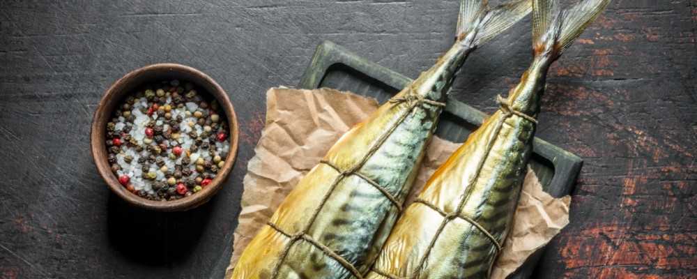 Appetizing Smoked Mackerel on Paper with Spices in Bowl