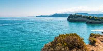 boats-sailing-on-sea-near-corfu-island-under-blue