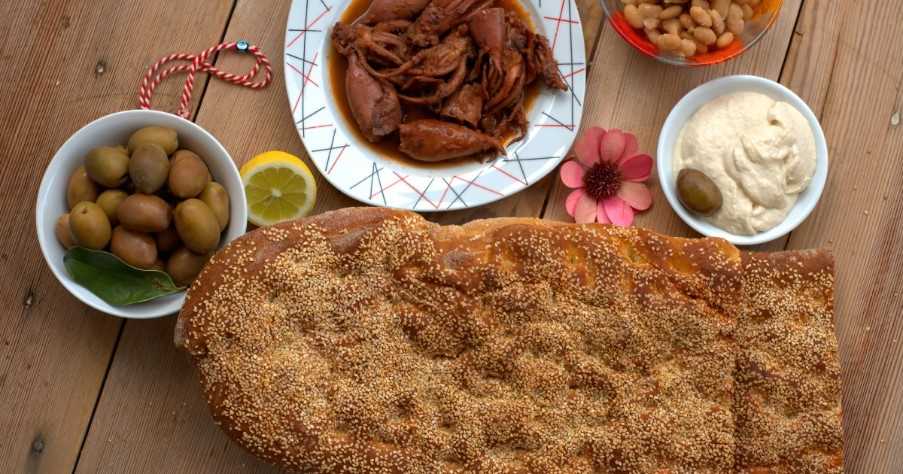 Traditional greek bread ( lagana ) ,olives ,seafood , greek taramas