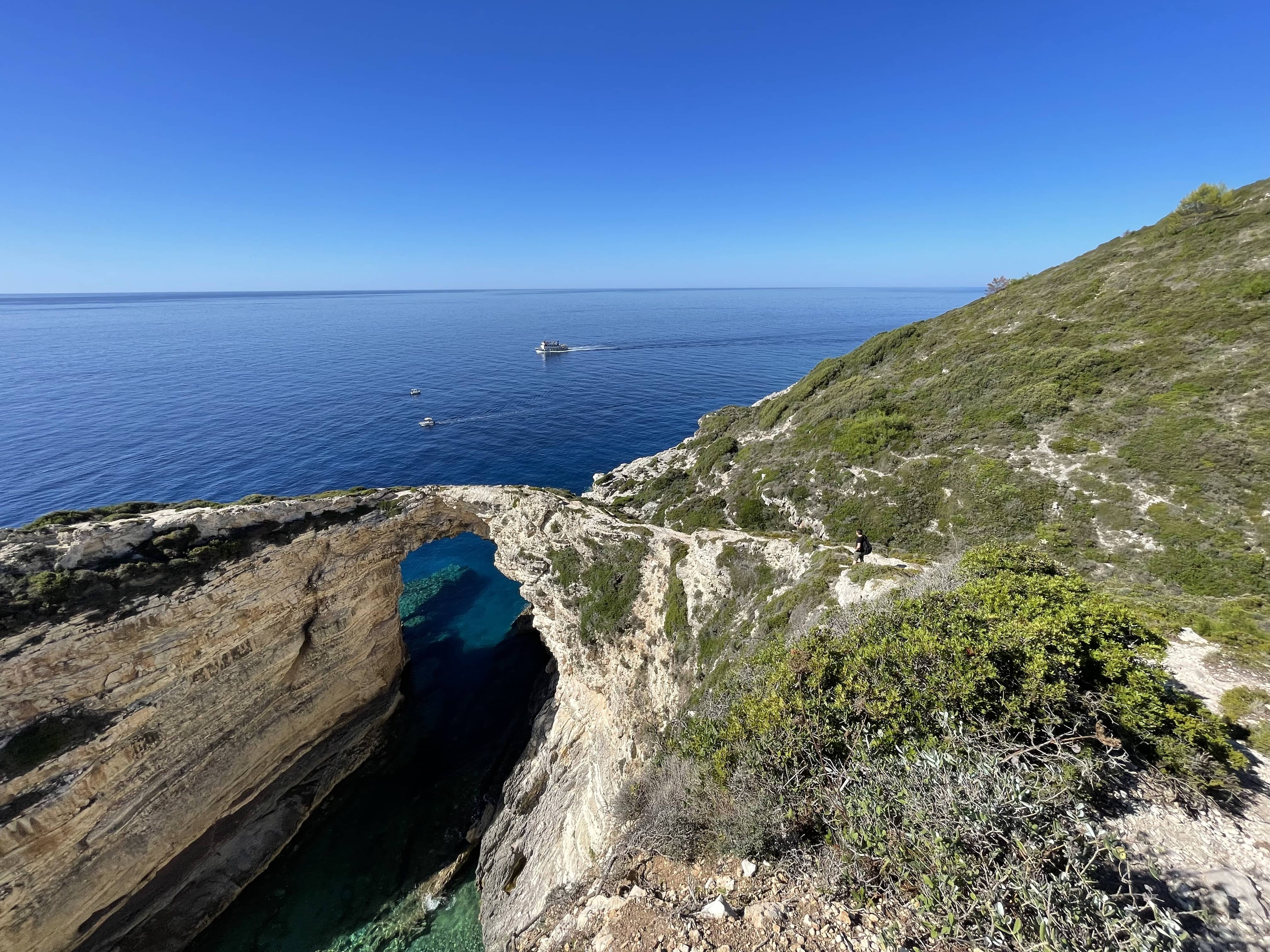 Walker On Tripitos Arch, Paxos, Greece